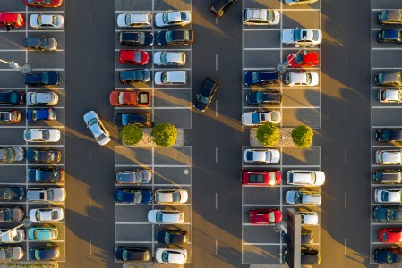 Top down view from drone on mall parking with many cars