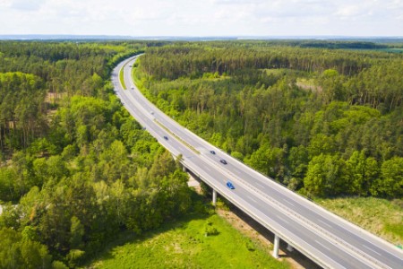 Aerial view of a highway going through the forest. D5 highway in Czech republic, European union.