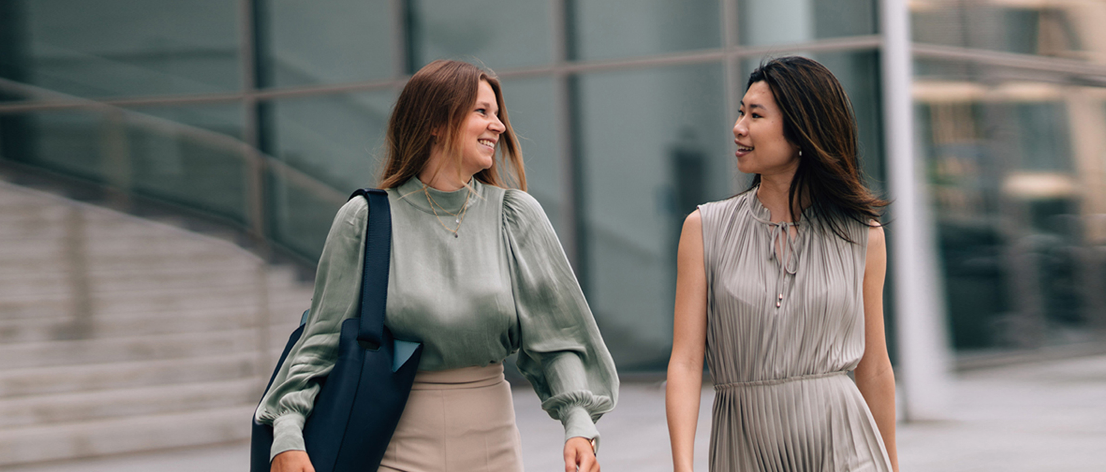 Two business women walking together
