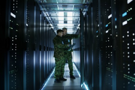 Two Military Men Work with Open Server Rack Cabinet. 