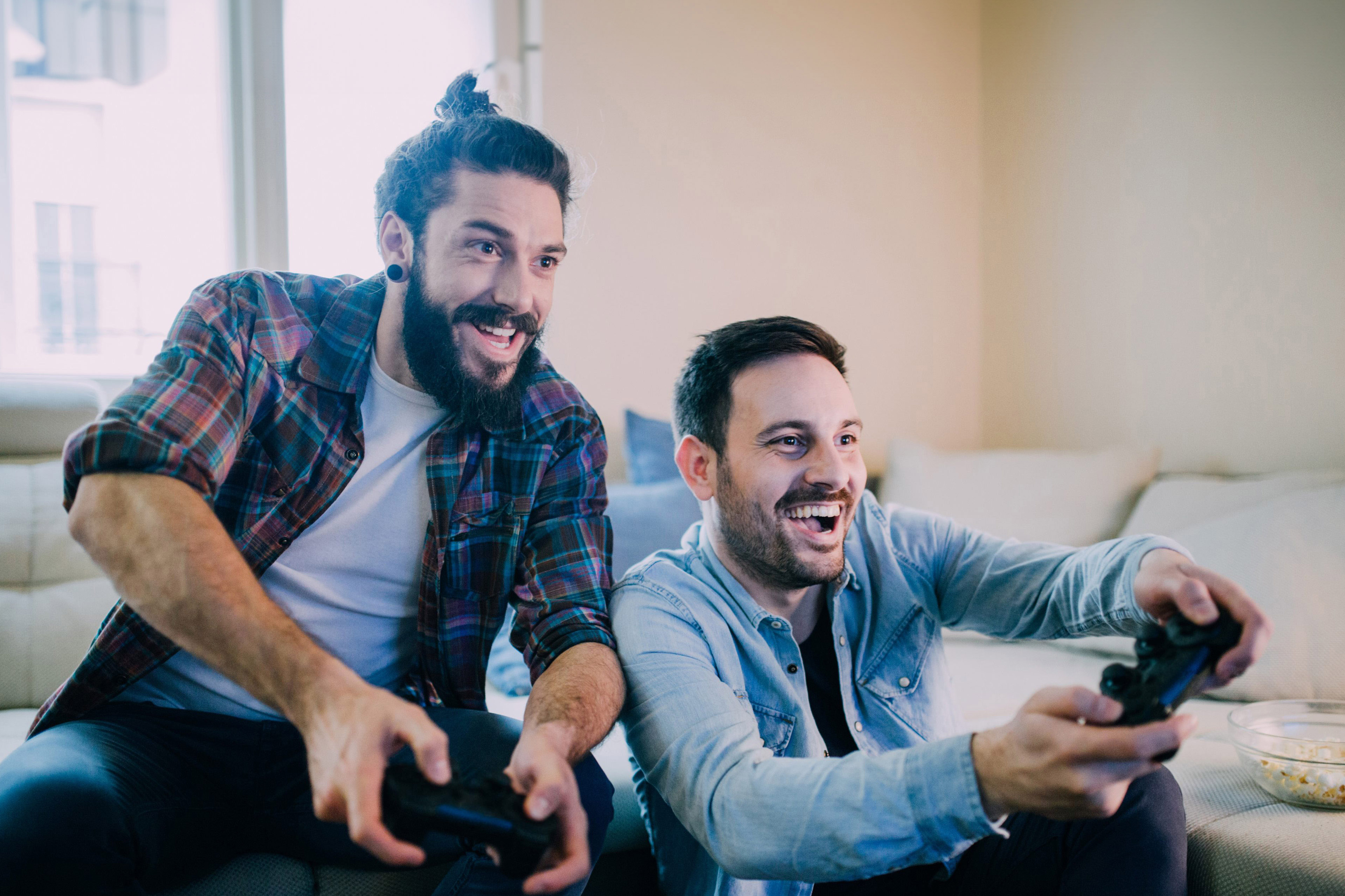Excited friends playing video games 