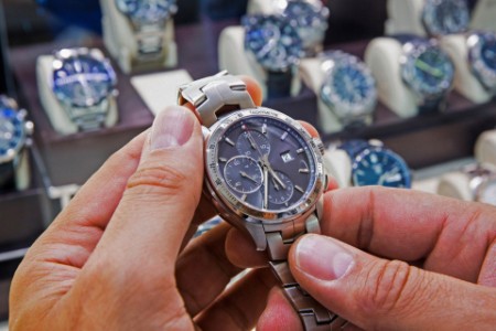 Herrenarmbanduhr, die in einem Uhrengeschäft gehalten wird