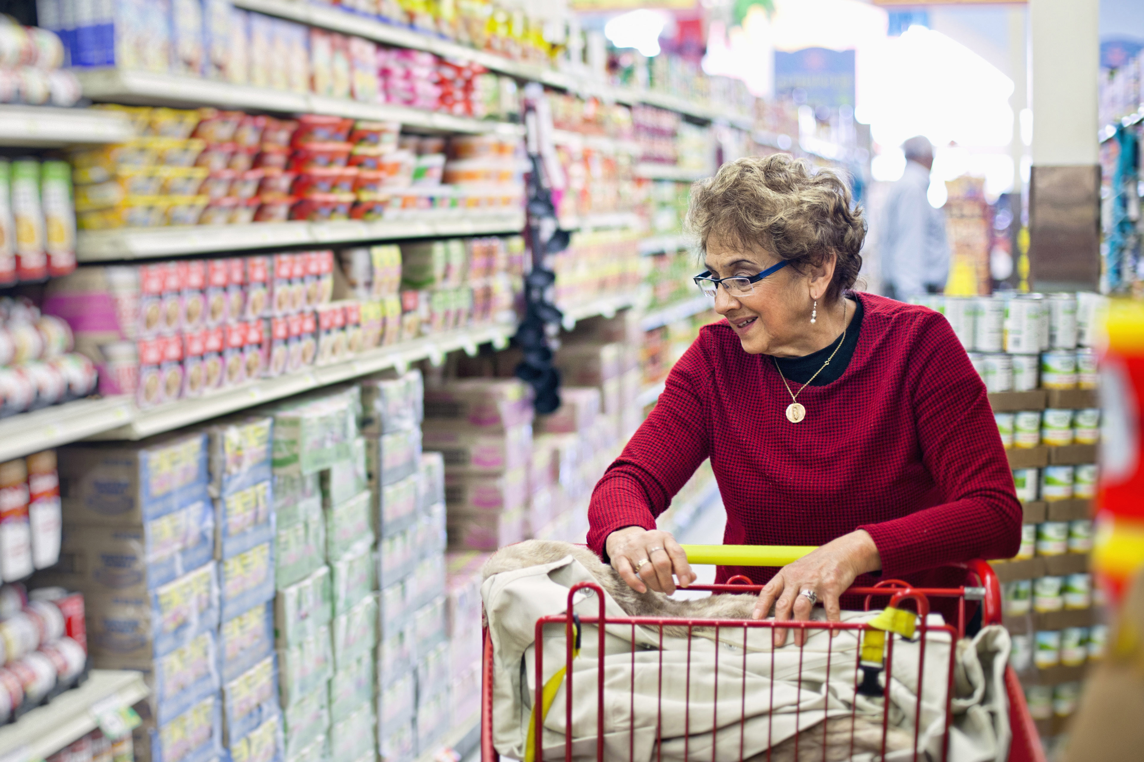 Senior hispanic woman shopping in grocery store