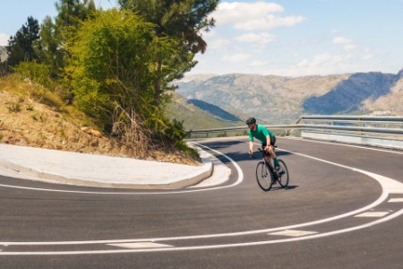 Radfahrer in einer Haarnadelkurve in den spanischen Bergen
