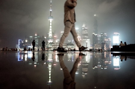 Man walking across city skyline