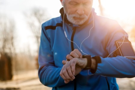 Elderly man using Smart Watch measuring heart rate