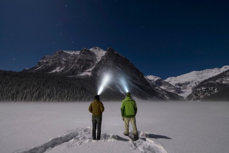 two-people-watching-mountain-using-light