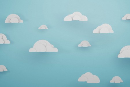 EY - Cartoon clouds isolated on blue sky background