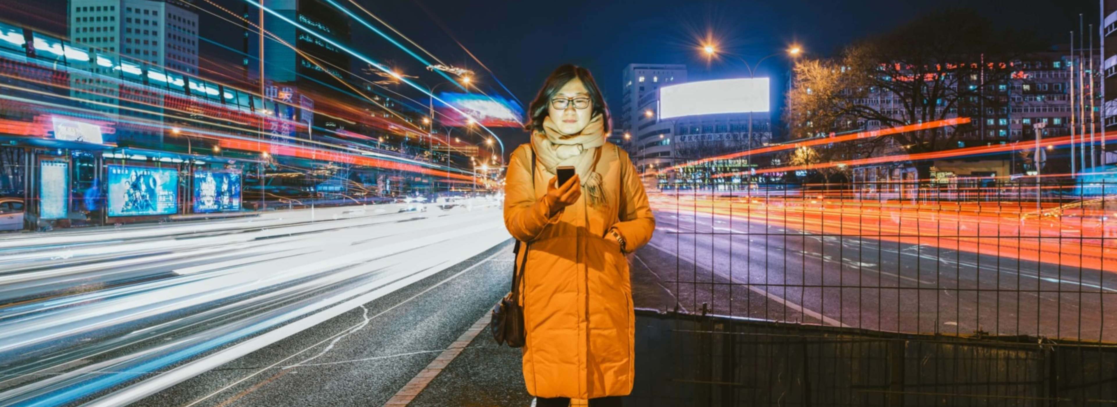 EY - Woman Using A Mobile Phone In Downtown District