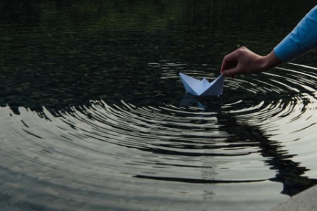 EY - Paper boat in water