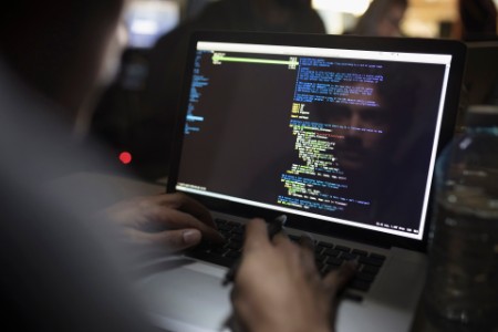 EY - Reflection male hacker coding laptop