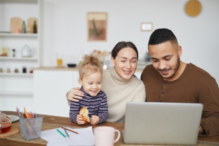EY - Family using laptop together while shopping online