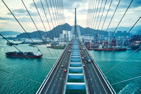 EY - Hong Kong Bridge with Container Cargo freight ship below