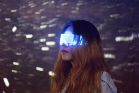 Woman wearing augmented reality glasses at night