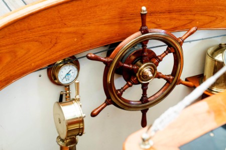Wooden steering wheel on a sea yacht