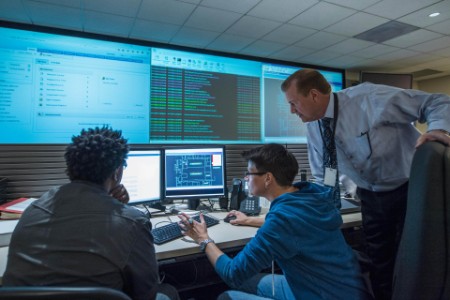 Colleagues working together in server control room