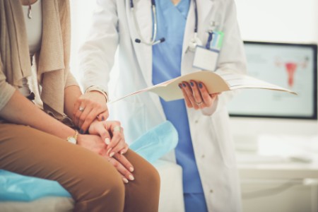 Doctor checking patient with records