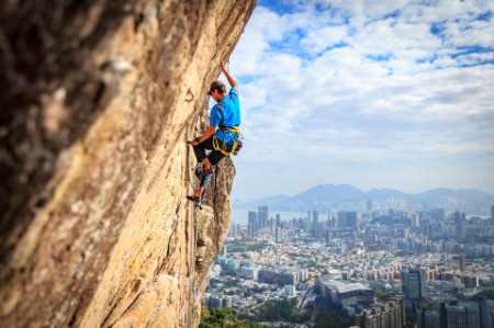 man climbing hong kong blue sky