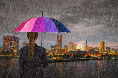 Picture of Business woman holding umbrella with falling rain at Yokohama city, Japan
