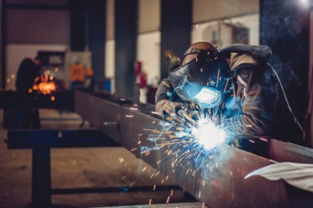 Steel workers welding steel