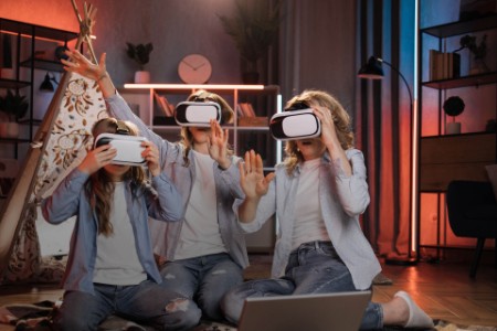 Happy mother and daughters using modern vr headset.