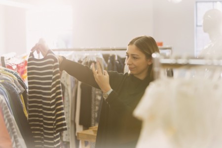 Fashion buyer photographing striped shirt