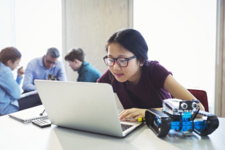 ey-focused-student-programming-robotics-laptop-classroom