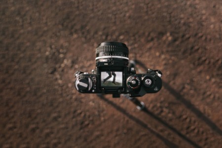 Person jumping seen through a camera viewfinder