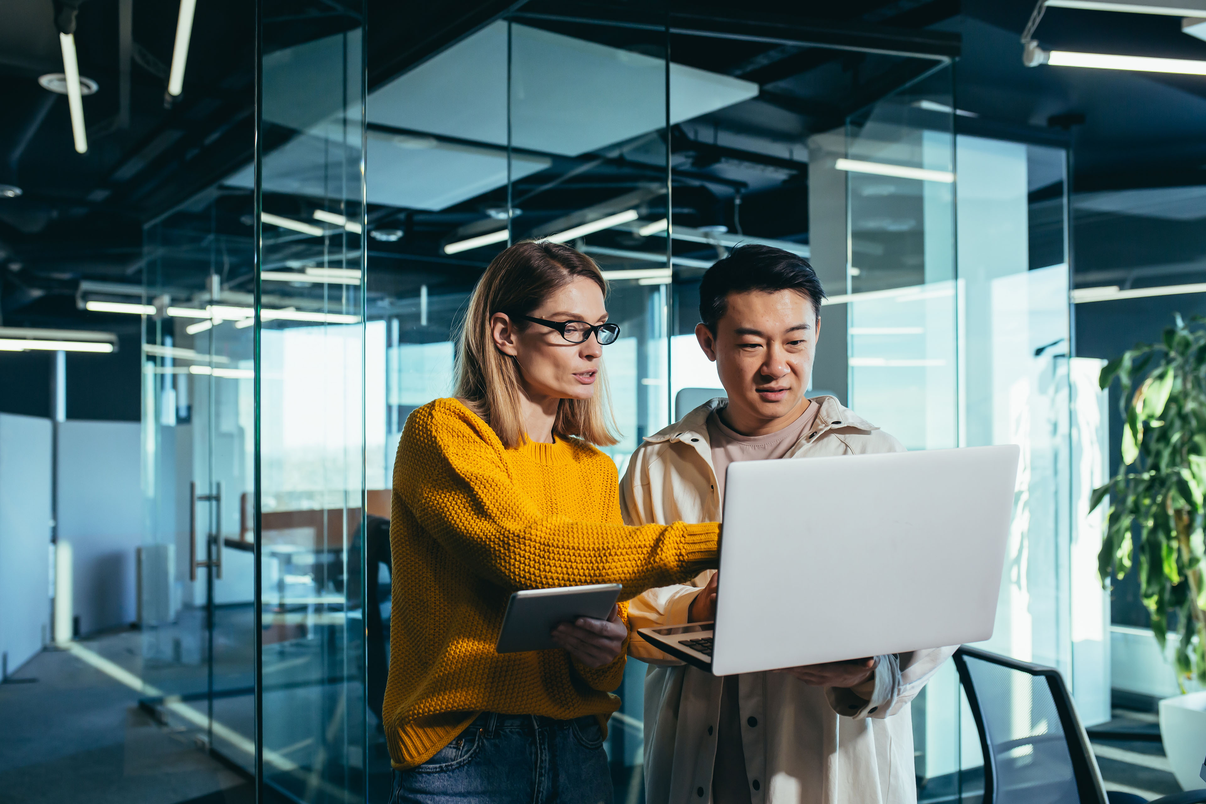 Business colleagues looking at a laptop screen in office