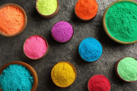 Colorful powder dyes on grey background