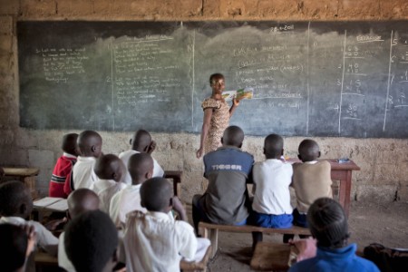 A teacher in rural classroom with students