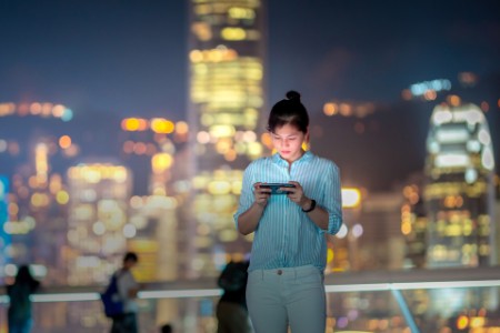 Woman using smartphone at night