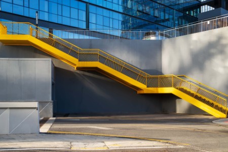 Yellow metal staircase beside in the office buildings