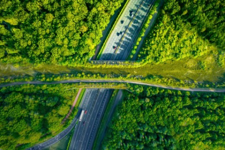Aerial directly above view of a green bridge ecoduct for fauna crossing above highway in the Western Europe