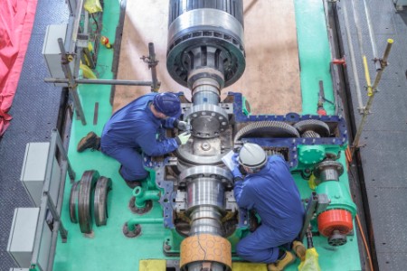 overhead-engineers-inspecting-gears-generator-turbine-hall