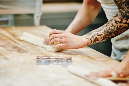 Bakers shaping dough baguettes bakery