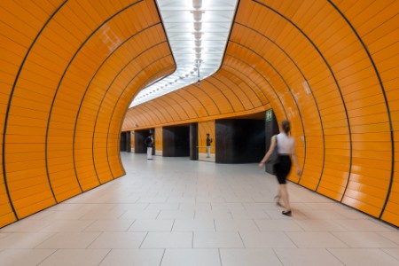 Rear view of woman walking in tunnel, Germany