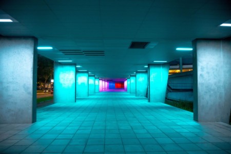 City underpass at night illuminated with colorful lights