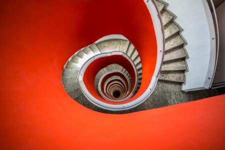 high angle view looking down a red spiral staircase