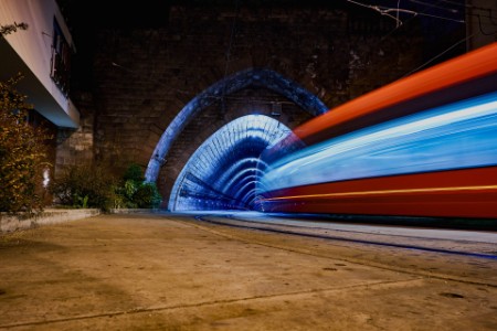 Light trails from bus entering a tunnel