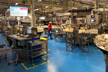 A worker is seen on the dish packing line