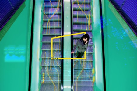 Japanese woman riding escalator