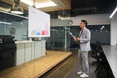 Businessman watching a creative graph in modern office