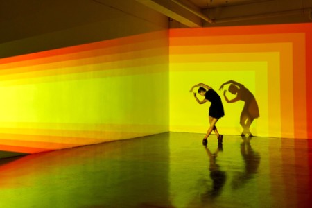 Girl dancing in a large space with graphic patterns