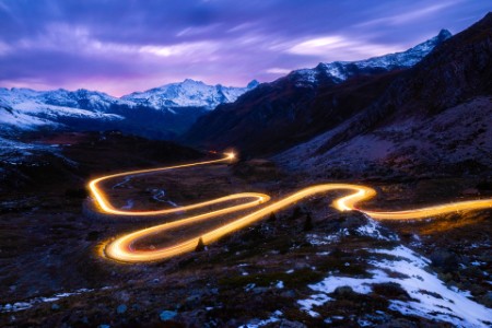 Light trails on swiss alps mountain pass road
