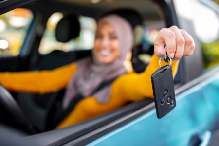 Woman Holding Car Key In New Vehicle