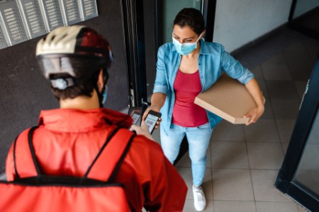 Woman paying for delivery pizza via mobile app