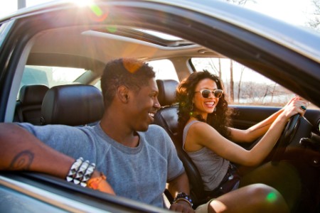Young couple smiling in car