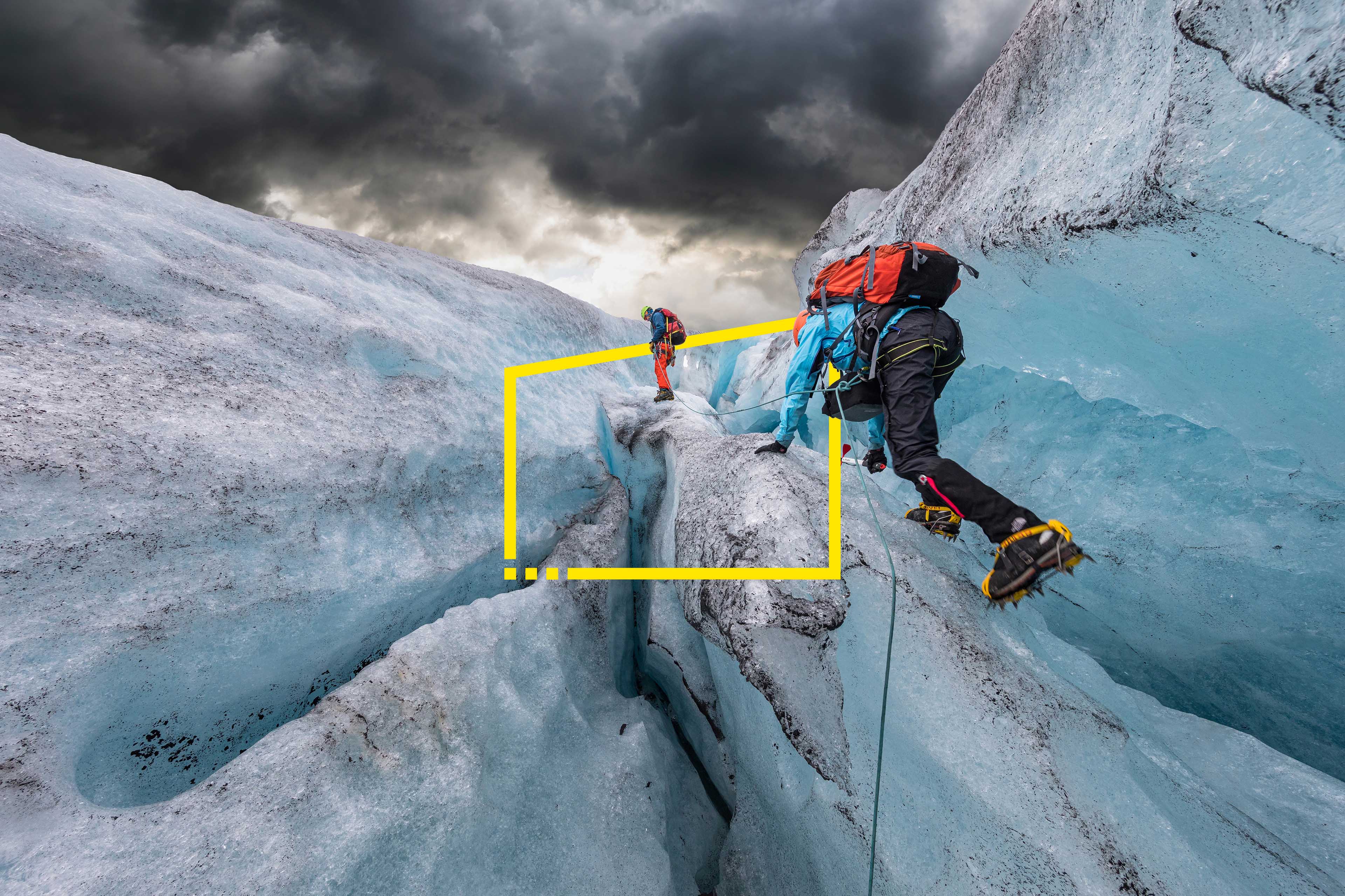 Two men hiking up a glacier