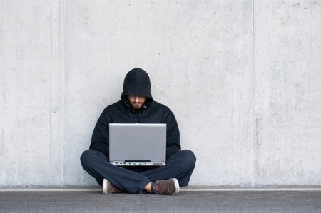 man hoodie sitting floor laptop